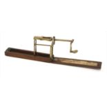 A mahogany cased brass folding coin scale,