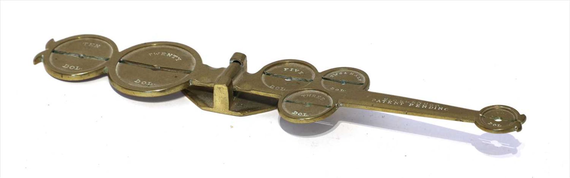 A brass counterfeit coin detector,