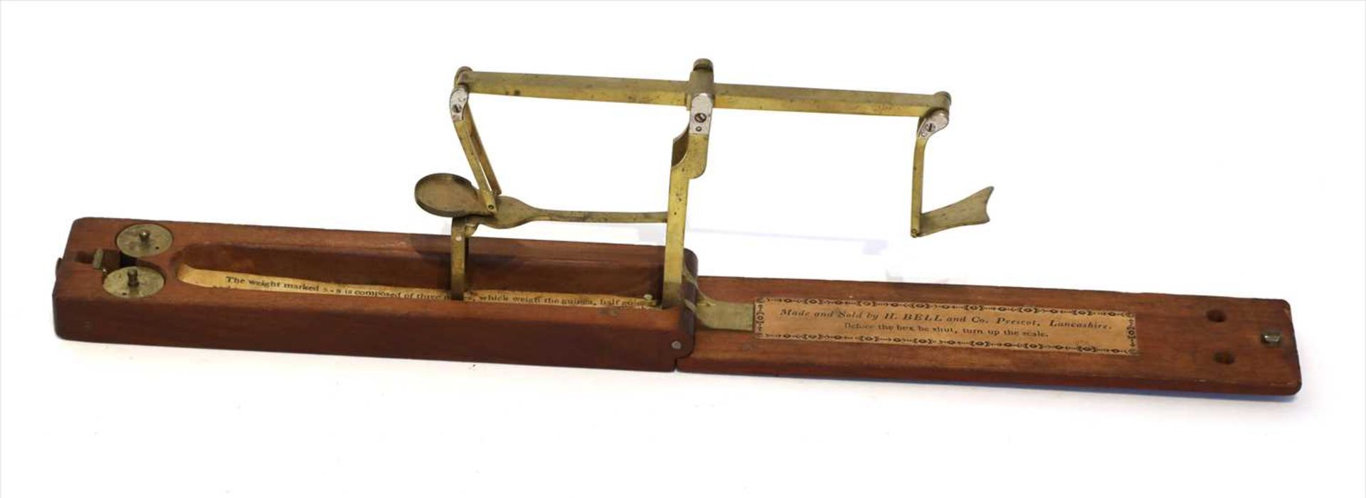 A mahogany cased equal arm brass folding coin scale,