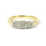 A gold three stone diamond ring,