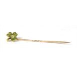 A gold demantoid garnet shamrock stick pin,