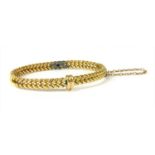 A gold oval hinged bangle,