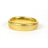 A 22ct gold court section wedding ring,