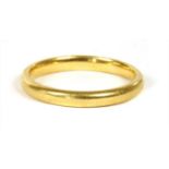 A 22ct gold court section wedding ring,