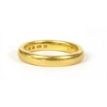 A 22ct gold court section wedding ring,