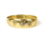 A gold three stone diamond ring,