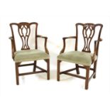 A pair of George III style mahogany elbow chairs,