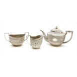 An Indian white metal three piece tea set,