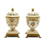 A pair of early 20th century Continental pot pourri vases and covers,
