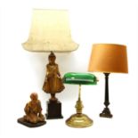 A carved and gilt figural table lamp,