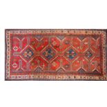 An oriental red ground rug,