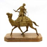 A gilt metal figure of a warrior atop a camel,