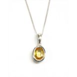 A white gold yellow sapphire pendant,