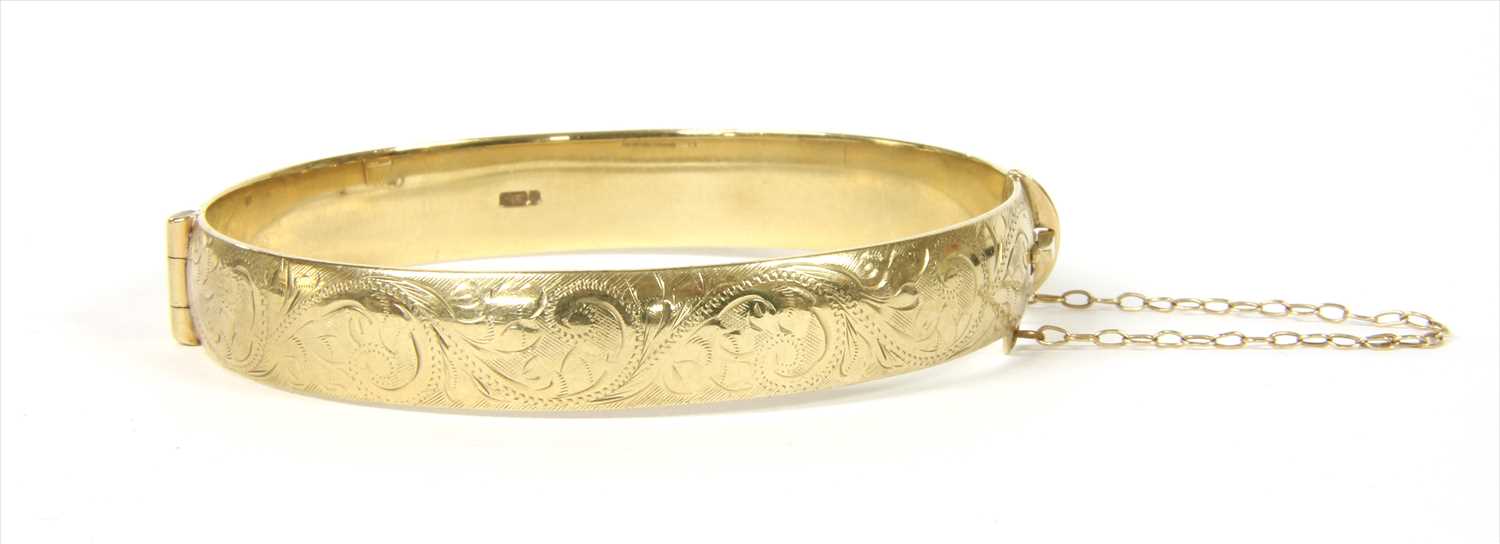 A 9ct gold hinged bangle,