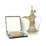 A modern silver Dallah coffee pot,