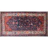 A blue ground Persian rug,