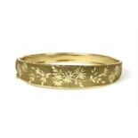 A 9ct gold hinged bangle,