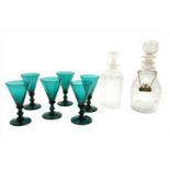 A set of seven green glass wine glasses,