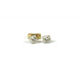 A pair of 18ct gold single stone diamond stud earrings,