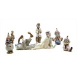 A collection of Lladro clown figures,