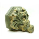 A green painted plaster wall bracket,