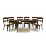 A George III inlaid mahogany extending dining table,