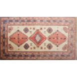 A Caucasian ivory red ground rug,