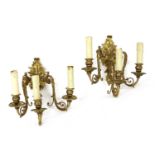 Six gilt metal three-branch wall lights,