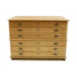 An early 20th century limed oak two section plans chest of six long drawers,