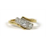 A gold three stone diamond ring,