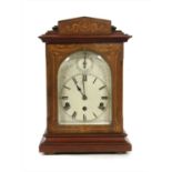 An inlaid mahogany mantel clock,