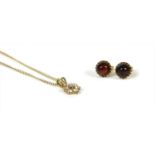 A pair of gold cabochon garnet stud earrings,