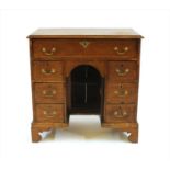 A walnut kneehole desk,