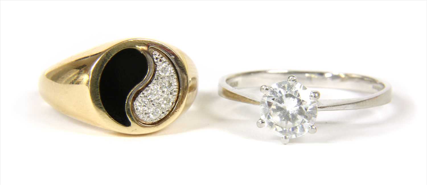 A gold diamond and enamel yin and yang ring,