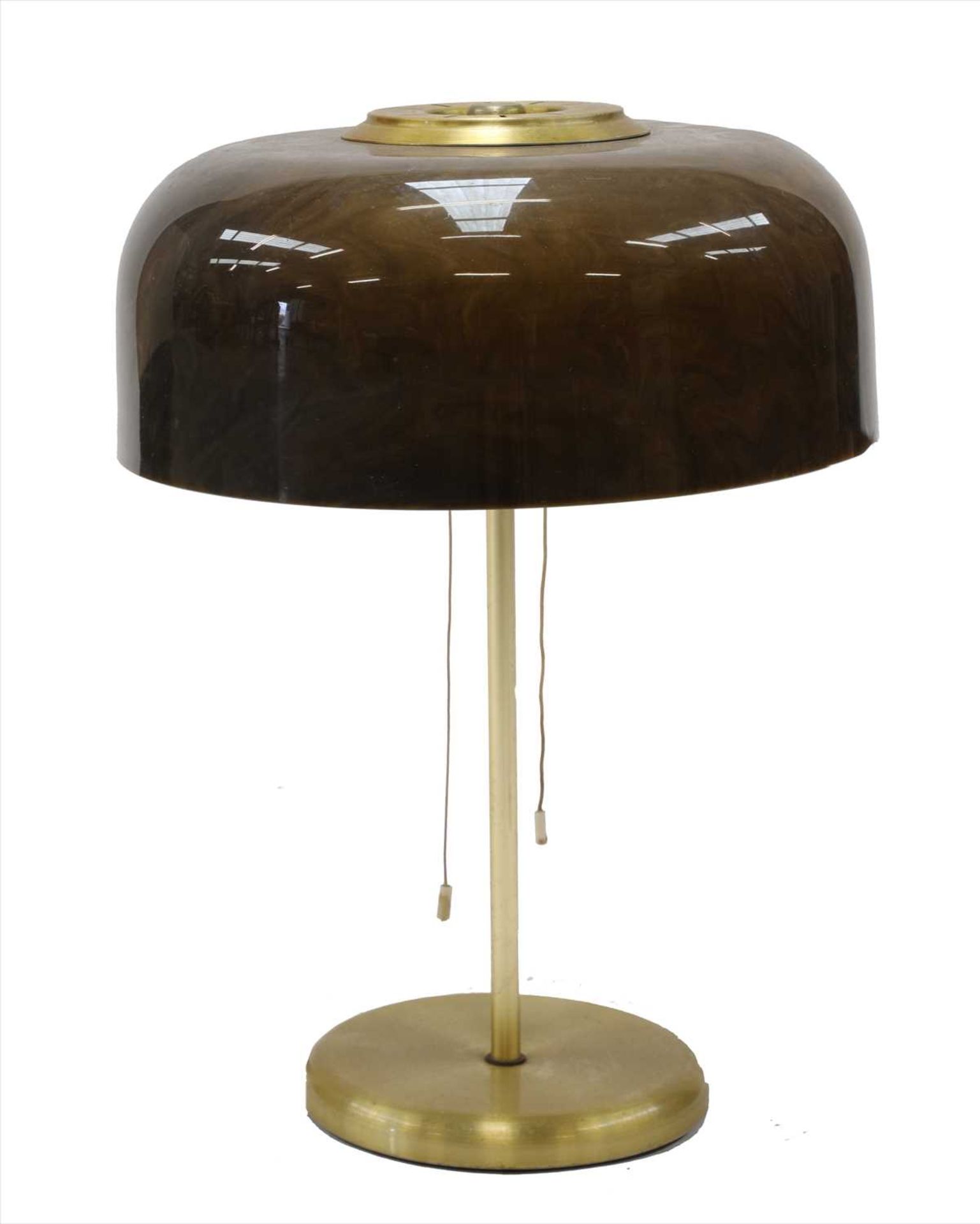 A table lamp with a domed plastic shade