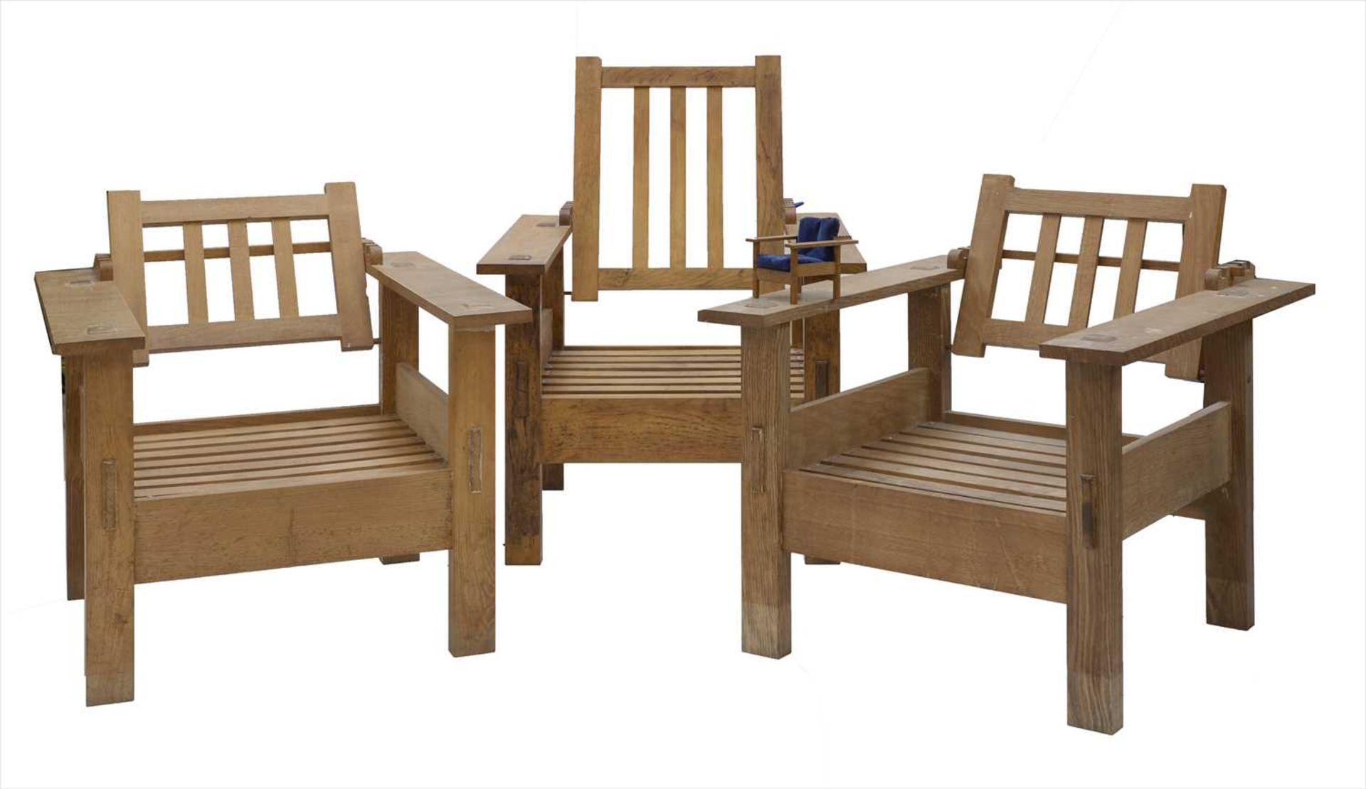 A set of three oak reclining chairs,