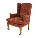 An Arts & Crafts oak wing back armchair,