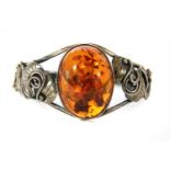 A sterling silver hinged amber bangle,