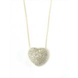 A gold diamond heart pendant,