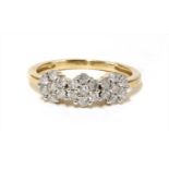 A gold diamond triple cluster ring,