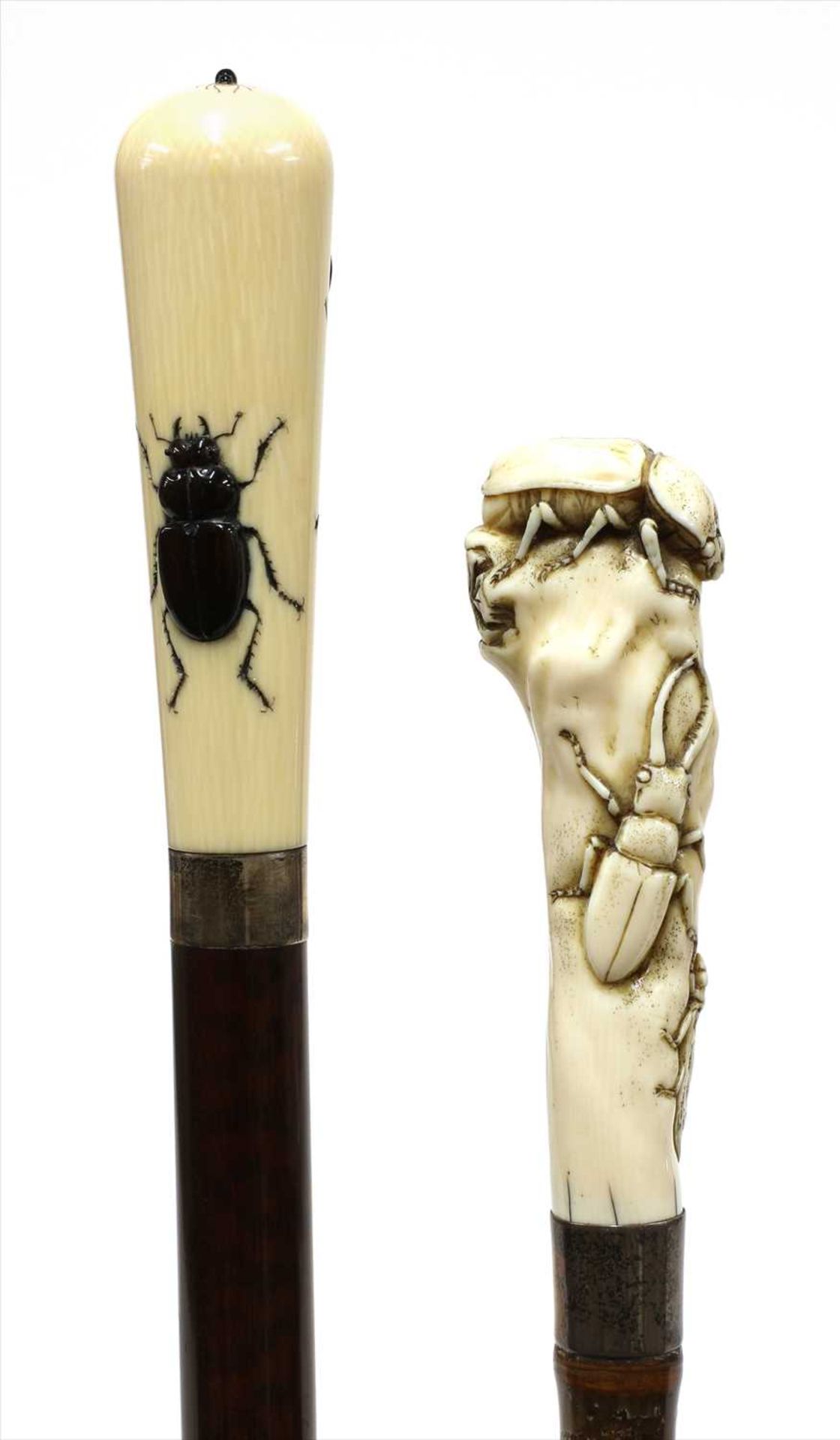 Two carved ivory walking sticks,