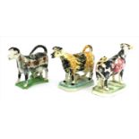 Three Staffordshire cow creamers,