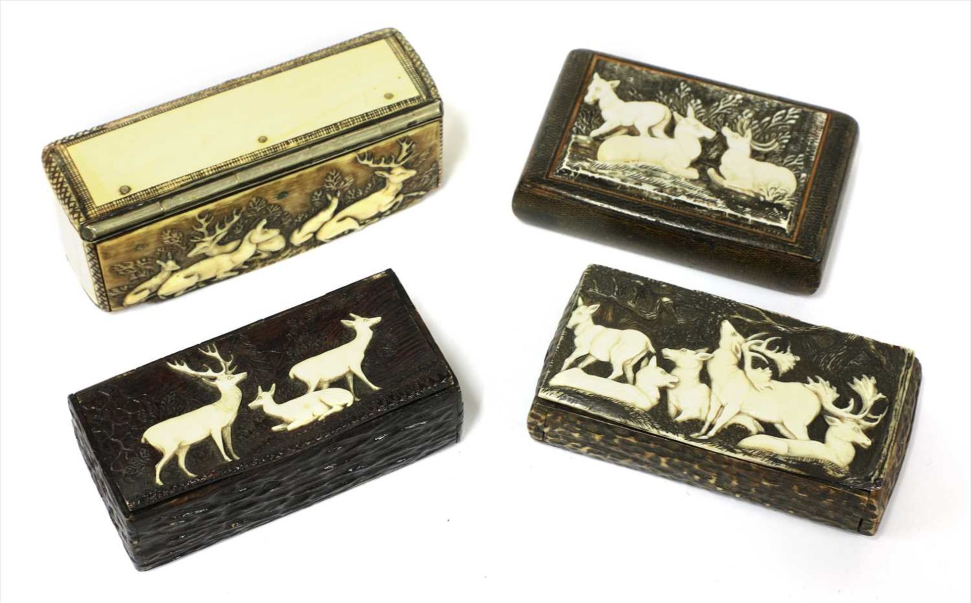 Four carved stag antler boxes,