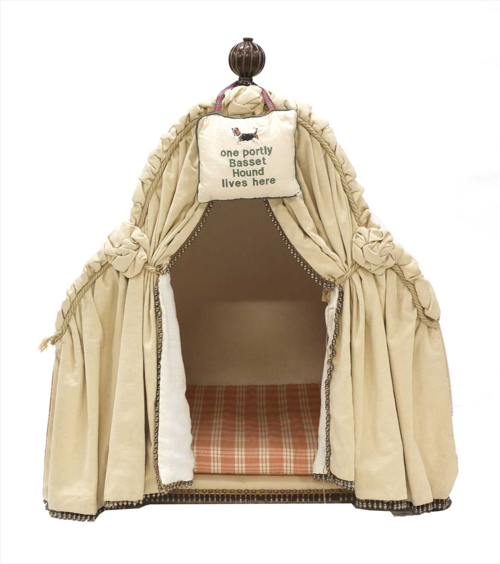 An upholstered dog kennel,