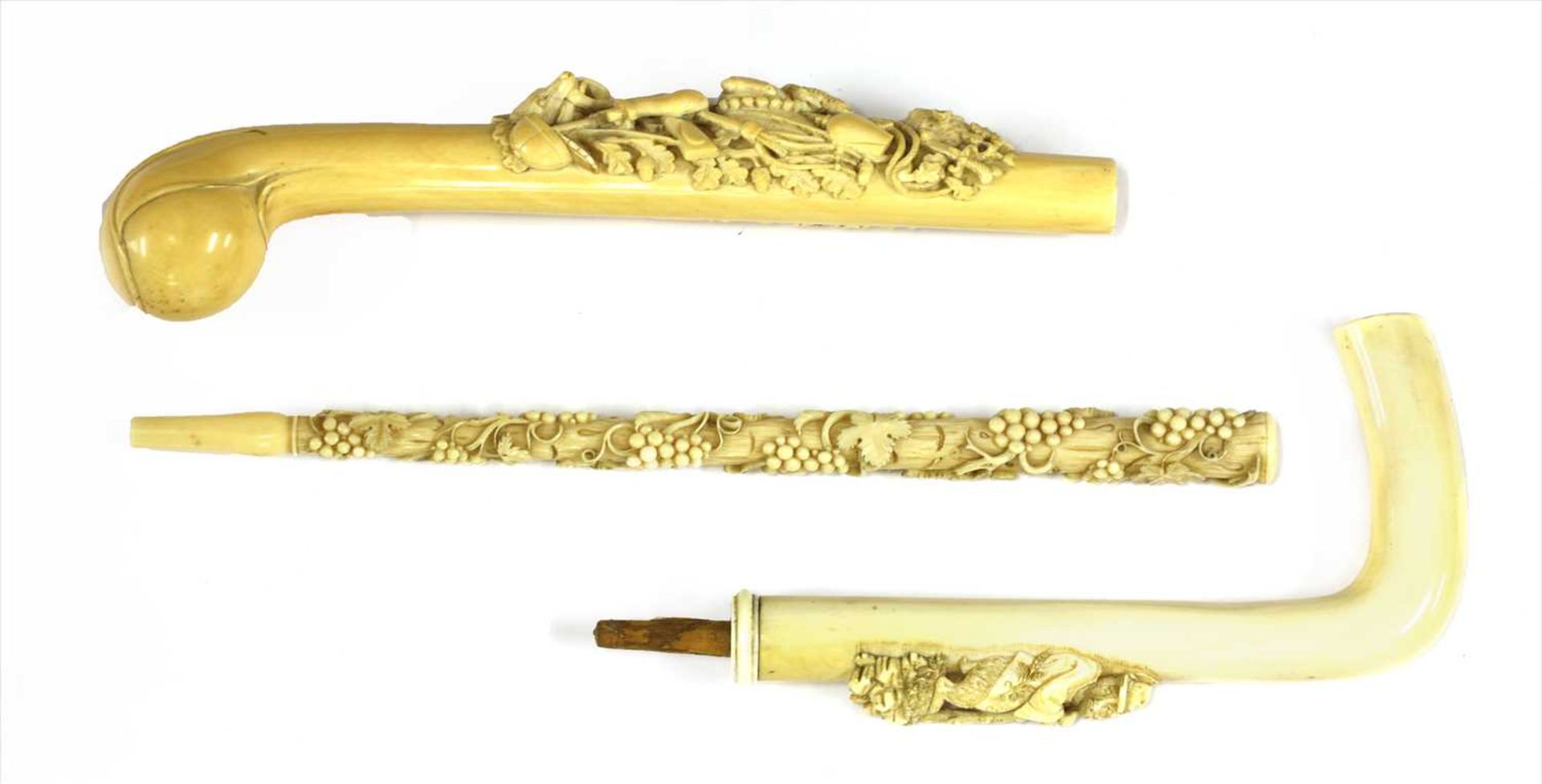 Three carved ivory parasol or walking stick handles,