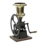 A large cast iron and polished brass coffee grinder,