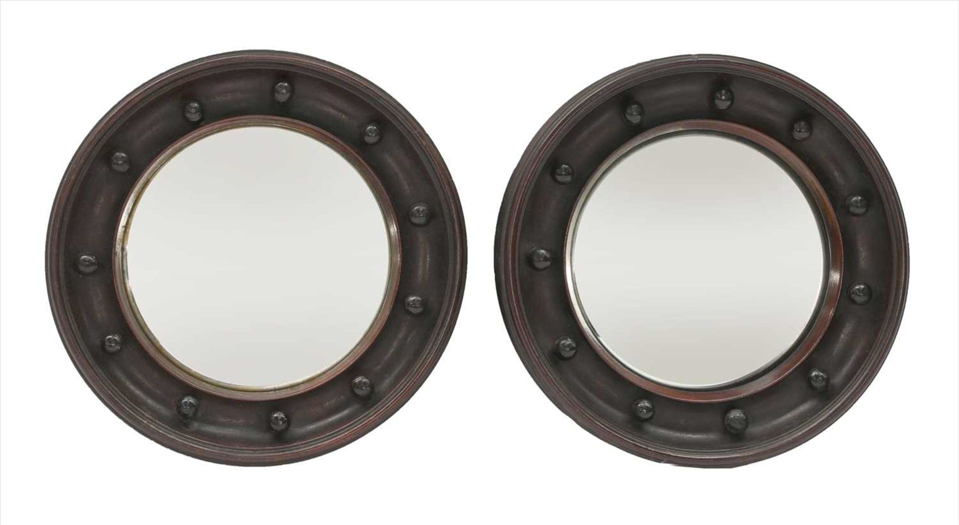 A pair of small mahogany-framed convex wall mirrors,
