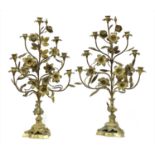 A pair of Continental floral gilt metal candlestick stands,