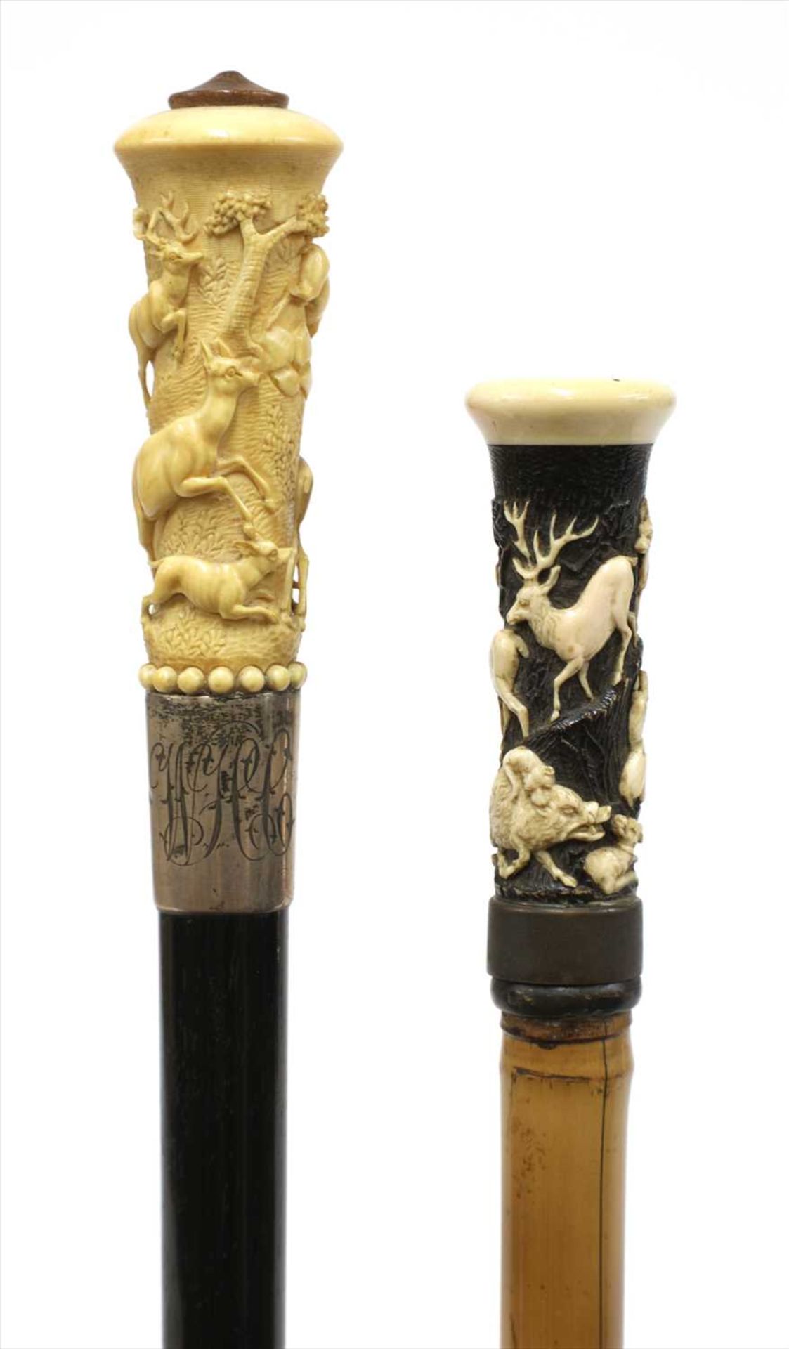 Two carved antler walking sticks,