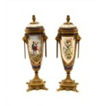 A pair of Sevres style lidded urns